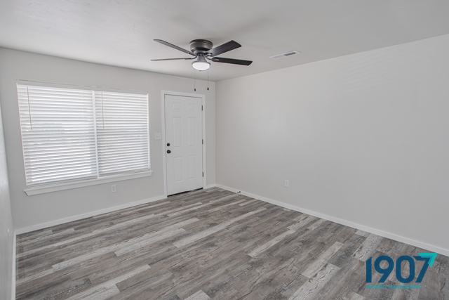 Living room with a wide window and new plank flooring