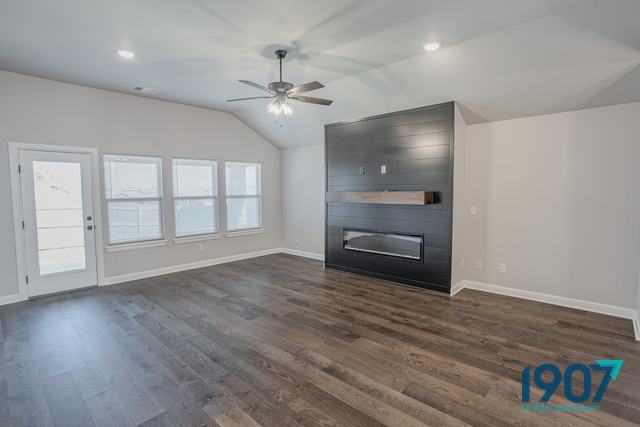Living room with a floor-to-ceiling fireplace wall