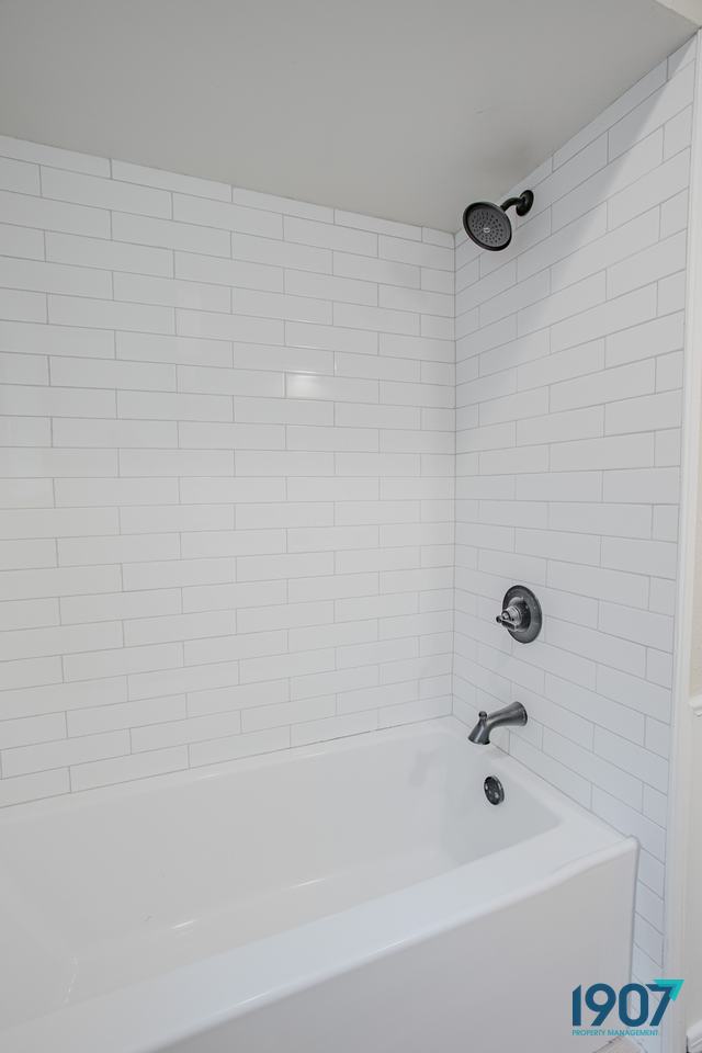 Tub with a white subway tile surround